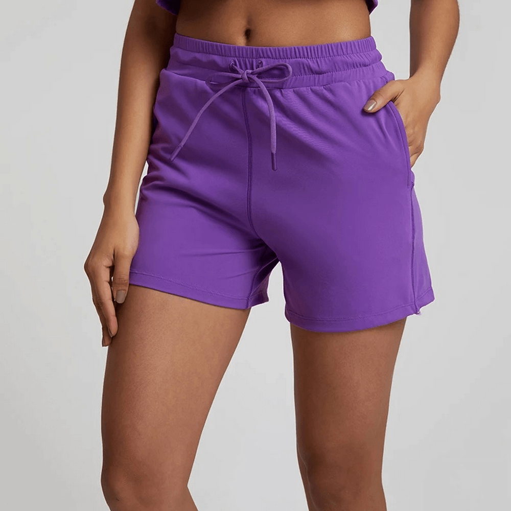 Purple women's workout shorts with elastic waistband, high waist, athletic design in solid color, perfect for gym or casual wear.